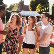 People socializing at an outdoor community event in Winston-Salem with music support for a public gathering.
