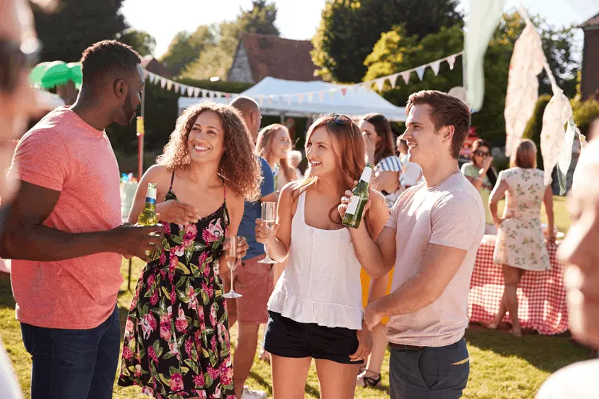 People socializing at an outdoor community event in Winston-Salem with music support for a public gathering.