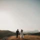 From 'I Do' to 'Let's Dance': Creating a Seamless Wedding Day Timeline 3 Bride & groom holding hands looking into the distance.