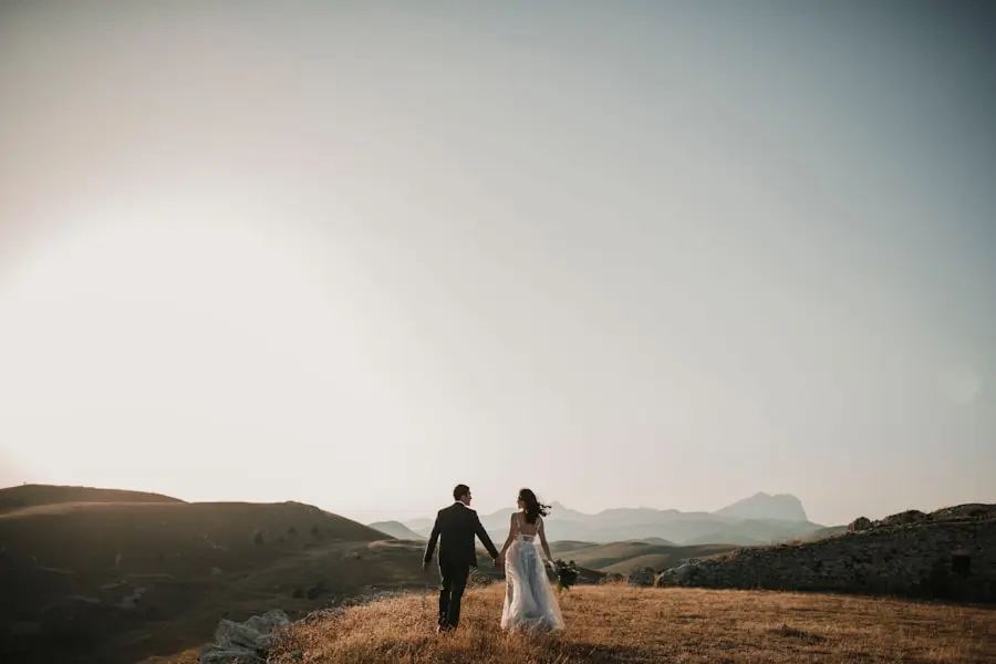 Bride & groom holding hands looking into the distance.