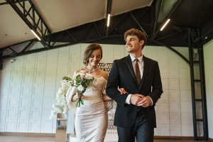 happy bride in white dress and groom in black suit