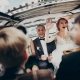 stylish happy bride and groom having fun in a limo