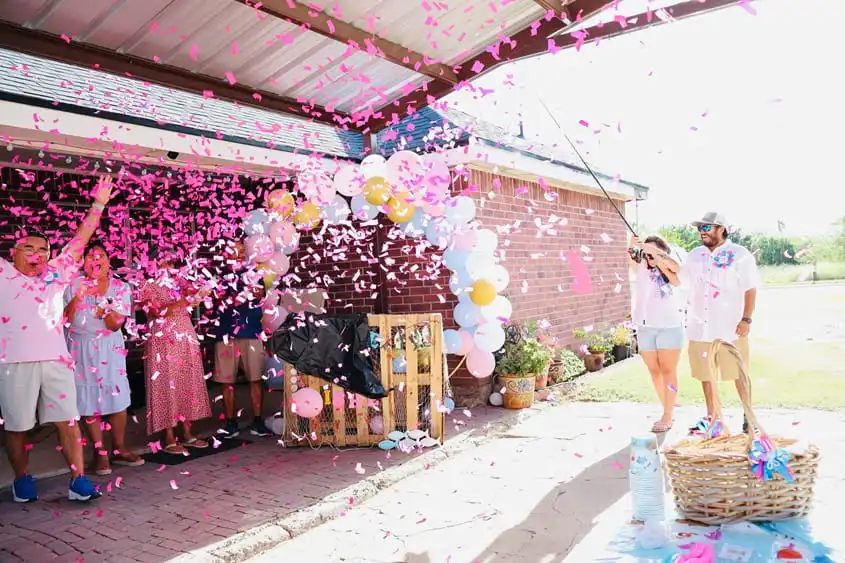 Guests cheering as confetti fills the air during a festive private party celebration outdoors.