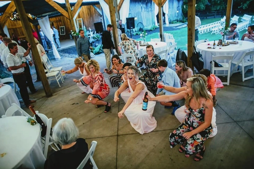 Wedding guests dancing together on a lively reception dance floor in Winston-Salem.